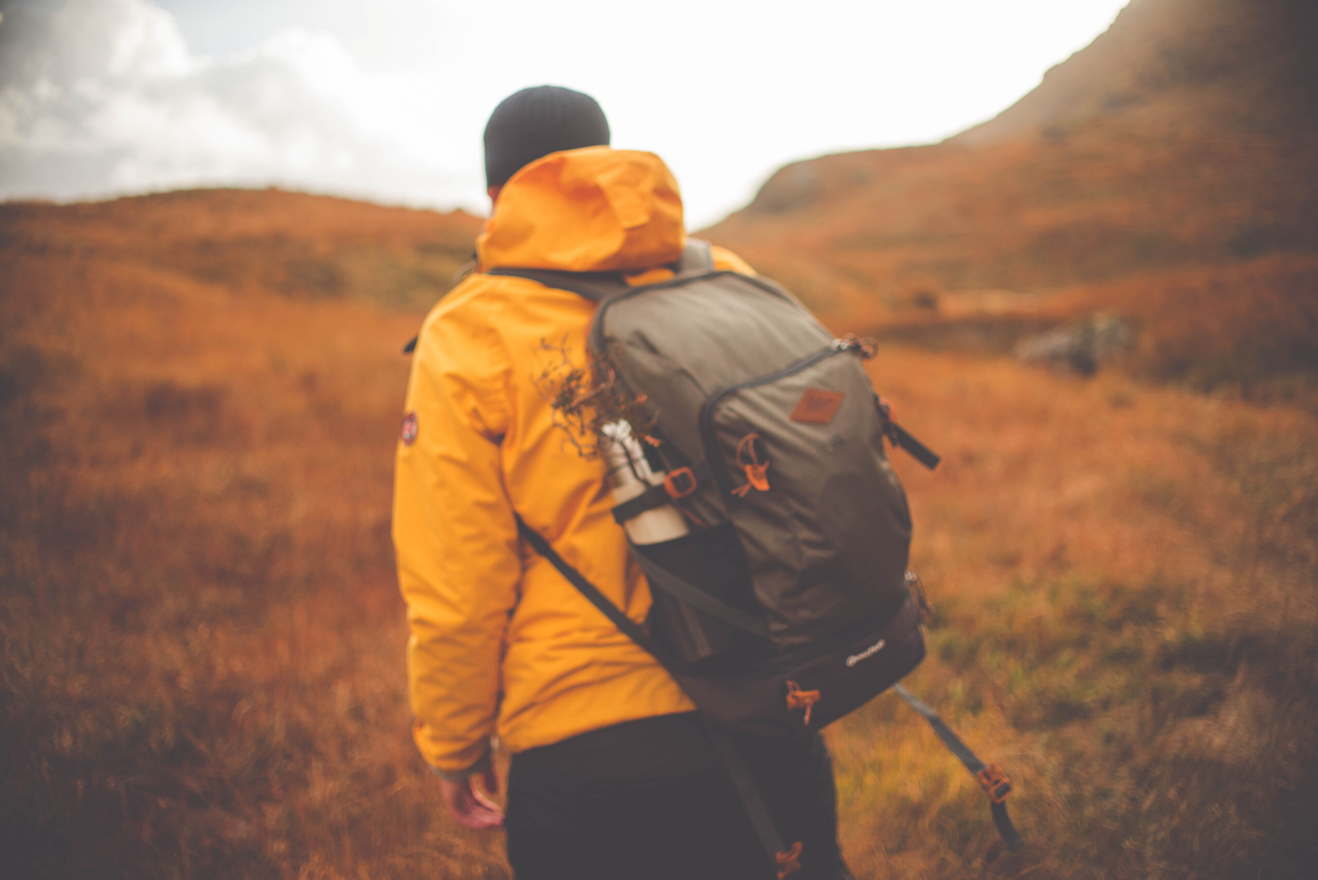 rear-view-man-with-backpack-hiking-mountain
